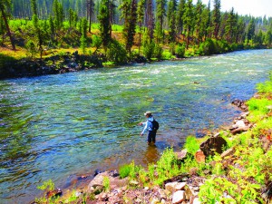 Shelley Walchak enjoys a quiet moment in the Little Wood River after her first success at fishing with streamers. Photo by Mike Hart 