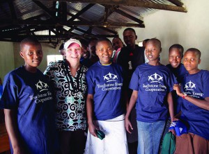 A co-op volunteer visits with a group of teens in Tanzania during a 2014 NRECA International project. 
