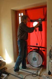 A blower door test during a home energy audit can help identify sources of air leakage. Photo Credit: Tõnu Mauring