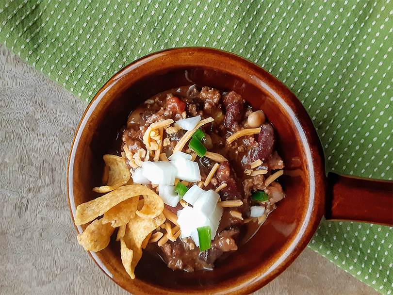 closeup of elk and venison chili in brown bowl