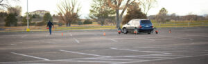 Michalkow sets up traffic cones in a parking lot before a driving class in the skid car.