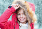 young girl in a pink parka coat